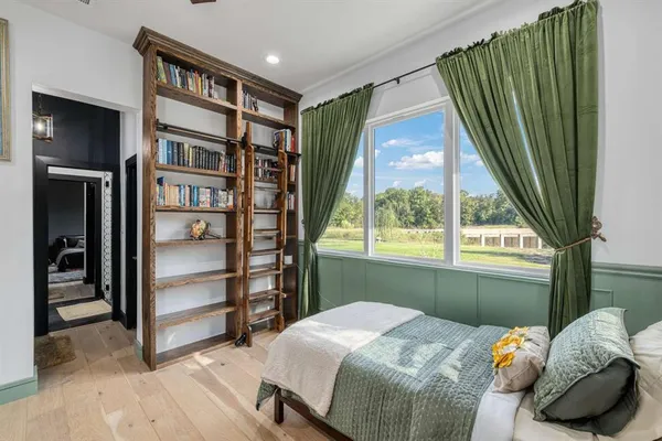 a bedroom with a bed and a large window
