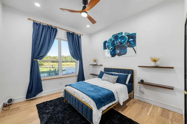 a bedroom with a large bed and a window