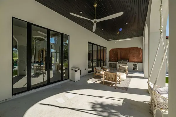 a view of a patio with couches next to a yard