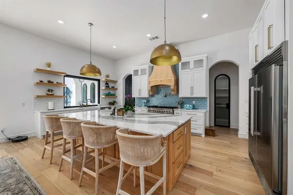 a large kitchen with a table and chairs