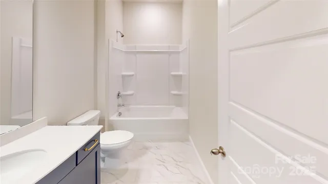 a bathroom with a granite countertop sink a toilet and bathtub