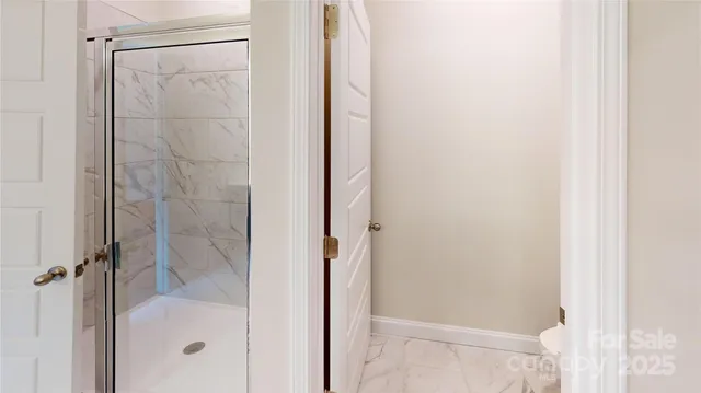 a bathroom with a glass shower door