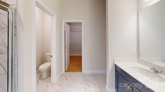 a view of bathroom with a toilet sink and mirror