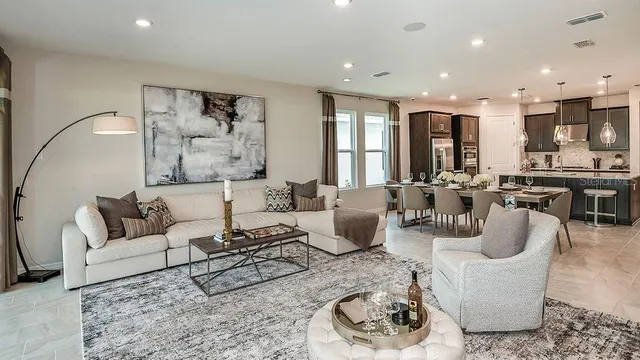 a living room with furniture and a view of kitchen