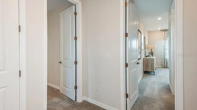 a bedroom with a bed a lamp and a large window