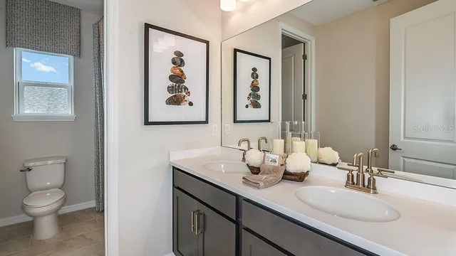 a bathroom with a granite countertop bathtub shower and toilet