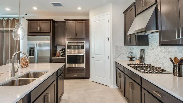 a kitchen with granite countertop a sink and white cabinets