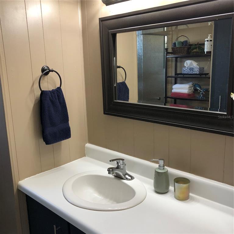 24437 Harbor View Road, Unit 12 Port Charlotte, FL 33980 - Photo 12 of 36 a bathroom with a sink and a mirror