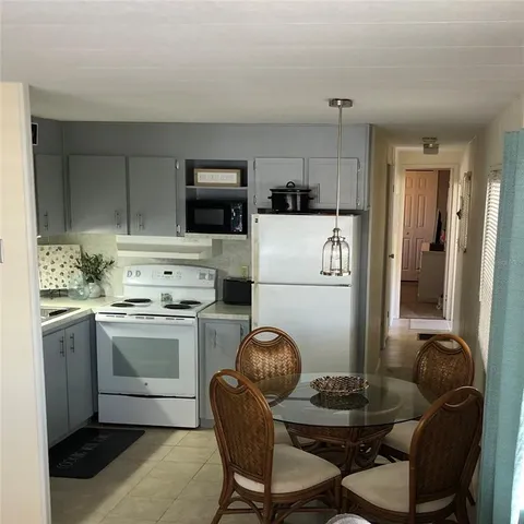 a kitchen with a dining table and chairs
