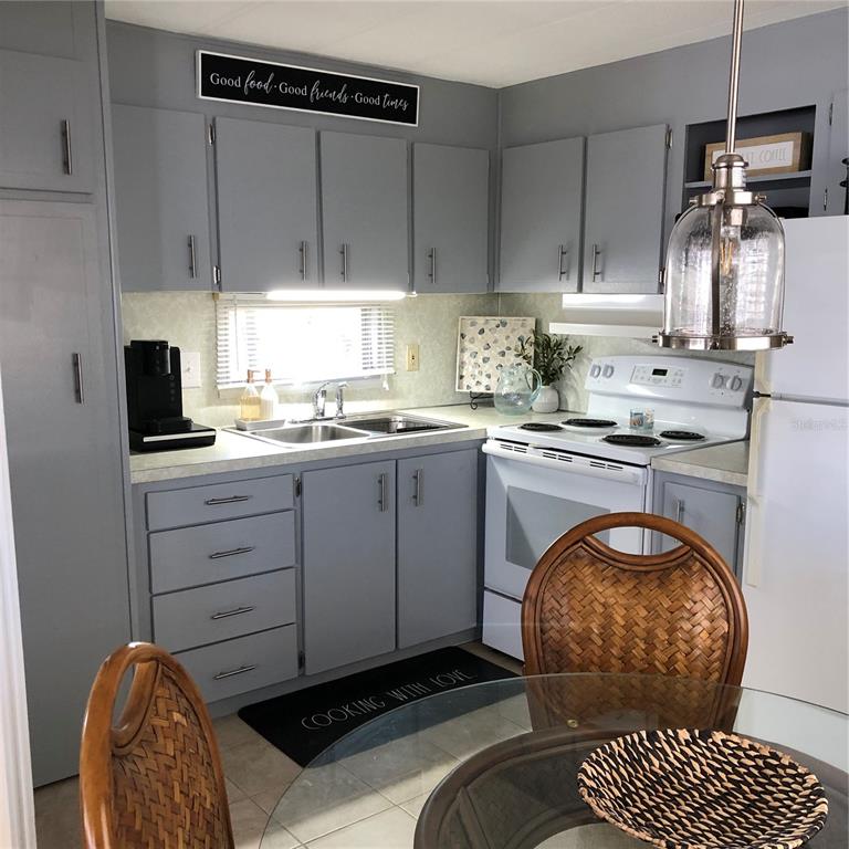 24437 Harbor View Road, Unit 12 Port Charlotte, FL 33980 - Photo 16 of 36 a kitchen with a sink cabinets and window