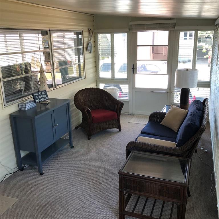 24437 Harbor View Road, Unit 12 Port Charlotte, FL 33980 - Photo 18 of 36 a living room with furniture and a window