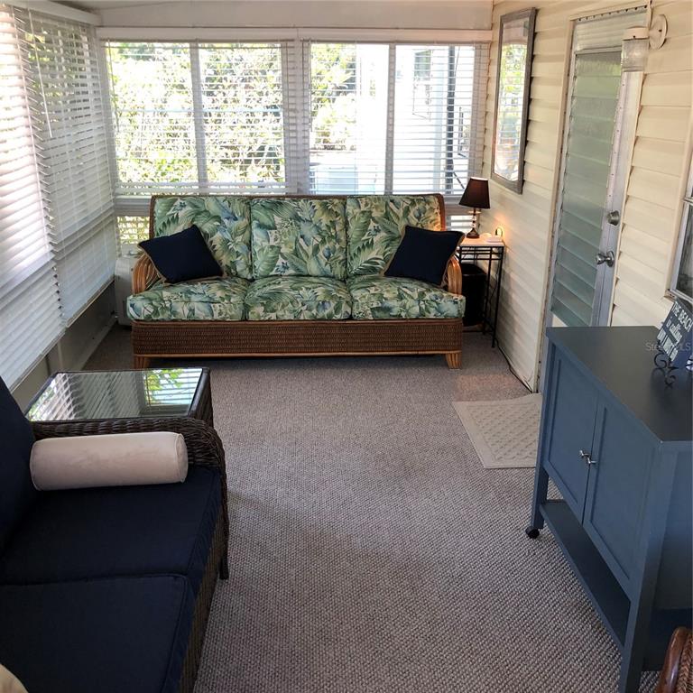 24437 Harbor View Road, Unit 12 Port Charlotte, FL 33980 - Photo 19 of 36 a living room with furniture and a large window