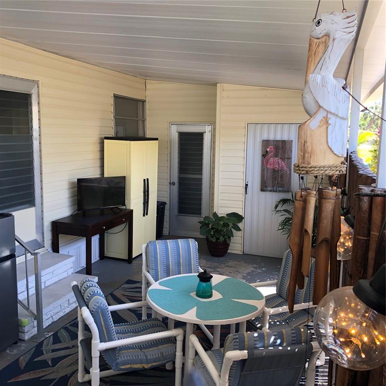 24437 Harbor View Road, Unit 12 Port Charlotte, FL 33980 - Photo 22 of 36 a view of a house with backyard and furniture
