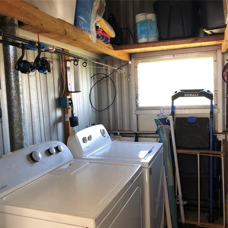 24437 Harbor View Road, Unit 12 Port Charlotte, FL 33980 - Photo 25 of 36 a utility room with dryer and washer