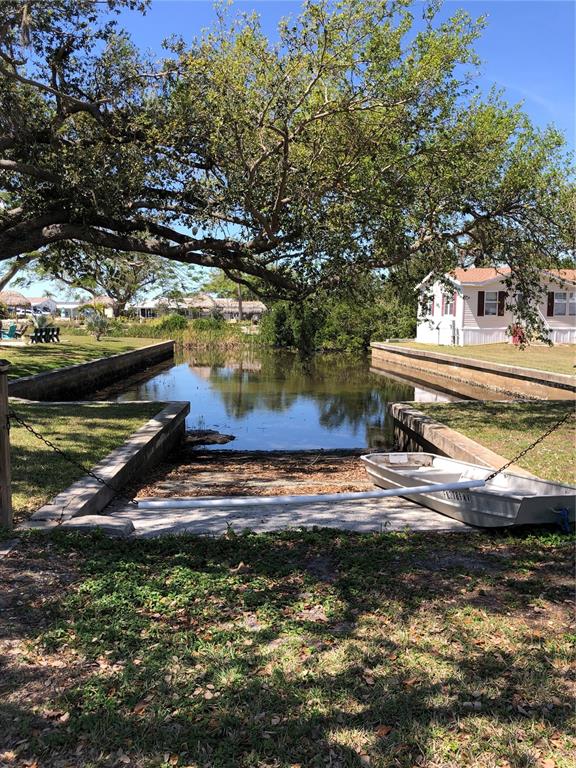 24437 Harbor View Road, Unit 12 Port Charlotte, FL 33980 - Photo 26 of 36 a view of a water fountain and a big yard