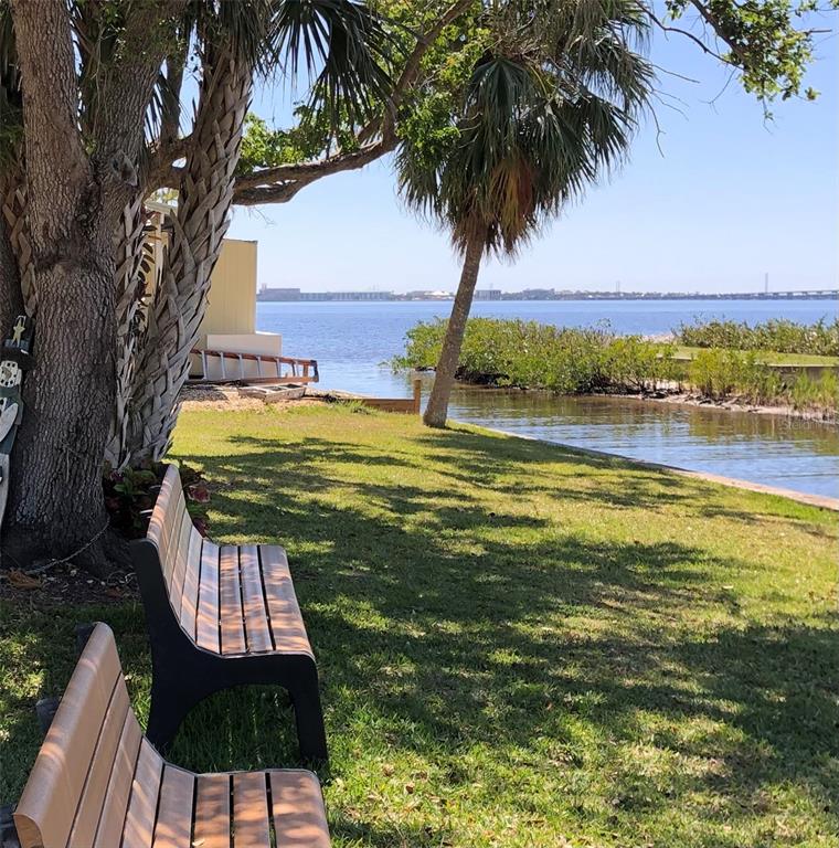 24437 Harbor View Road, Unit 12 Port Charlotte, FL 33980 - Photo 28 of 36 a view of a swimming pool with a table and chairs