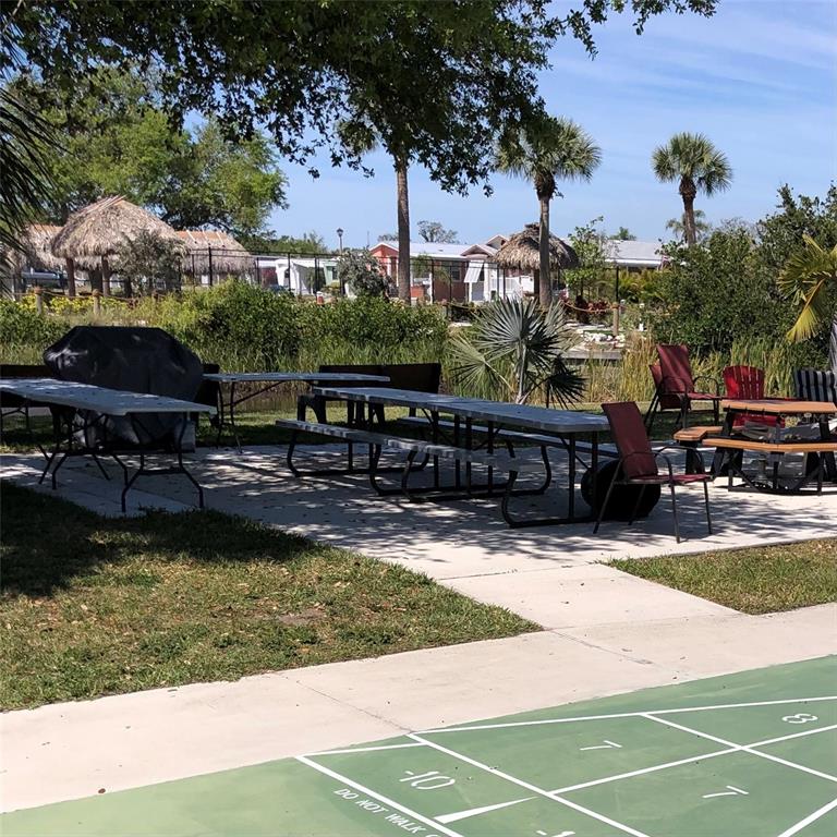 24437 Harbor View Road, Unit 12 Port Charlotte, FL 33980 - Photo 30 of 36 a view of a swimming pool with a patio