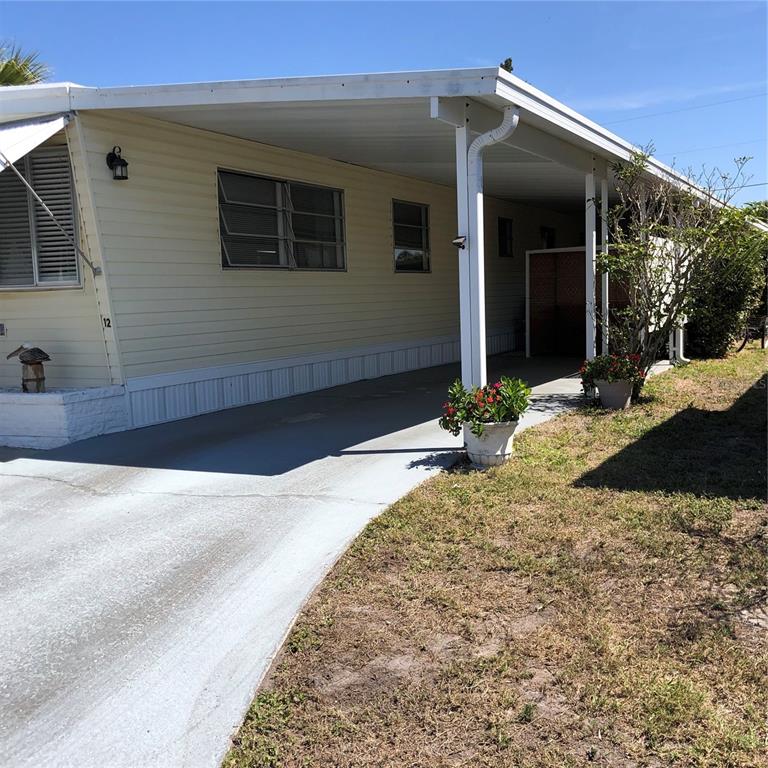 24437 Harbor View Road, Unit 12 Port Charlotte, FL 33980 - Photo 4 of 36 a view of a house with a yard