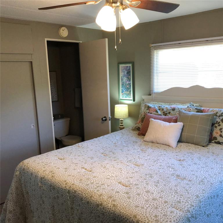 24437 Harbor View Road, Unit 12 Port Charlotte, FL 33980 - Photo 7 of 36 a bedroom with a large bed and a window