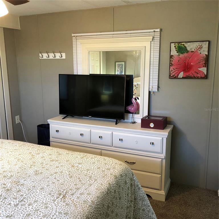 24437 Harbor View Road, Unit 12 Port Charlotte, FL 33980 - Photo 8 of 36 a room with flat screen tv