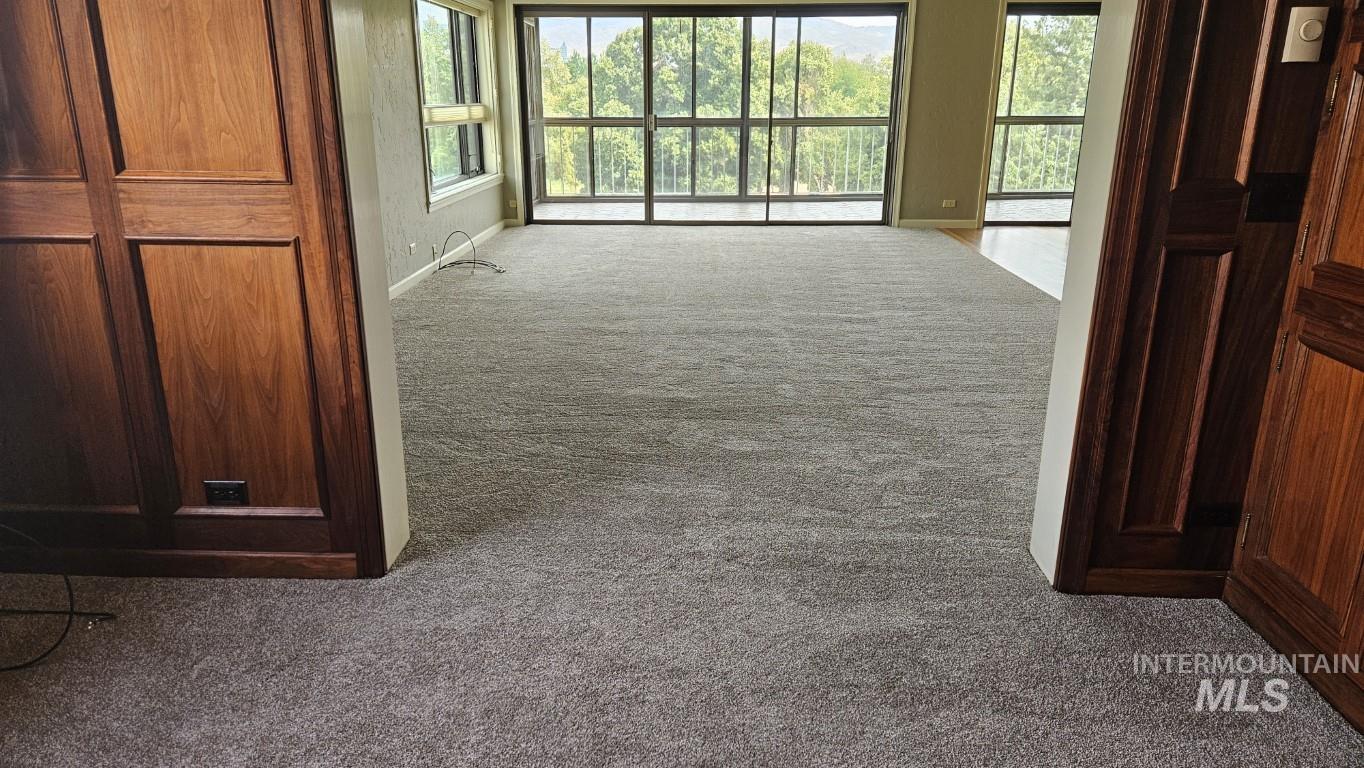3100 Crescent Rim Drive, Unit 308 Boise, ID 83706 - Photo 4 of 34 Hall featuring dark colored carpet and plenty of natural light