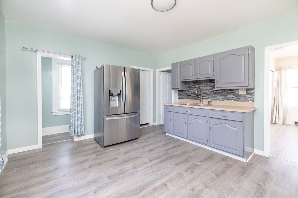 60 Roy Street Chicopee, MA 01013 - Photo 16 of 39 a kitchen with a refrigerator stove and wooden cabinets