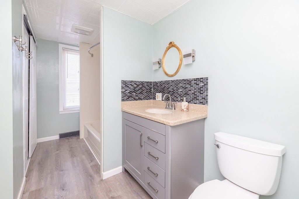 60 Roy Street Chicopee, MA 01013 - Photo 19 of 39 a bathroom with a toilet a sink and mirror