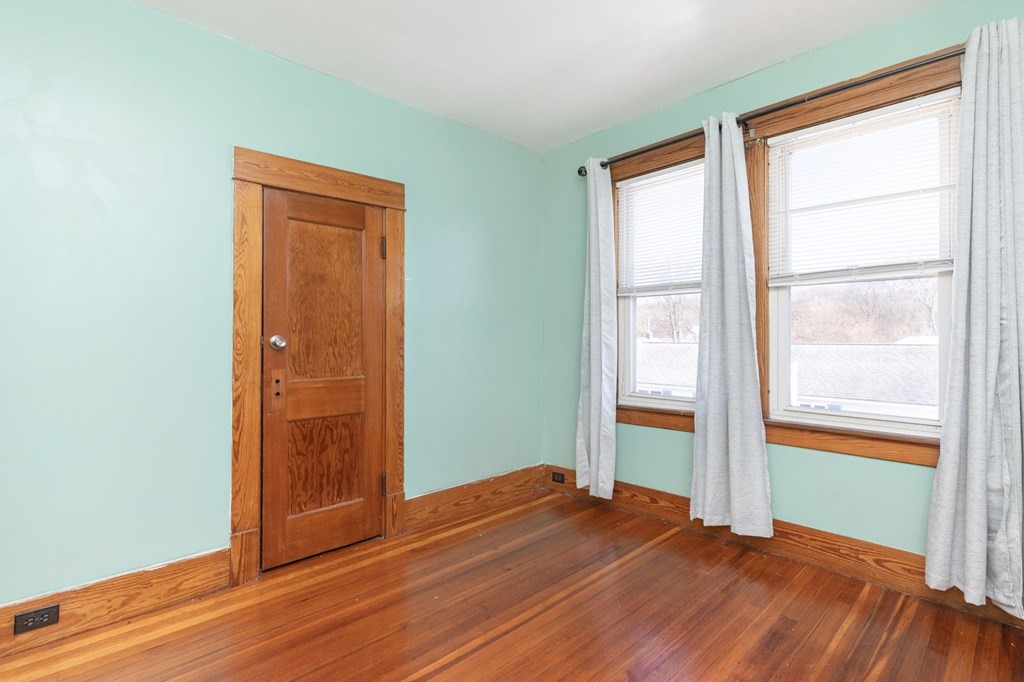60 Roy Street Chicopee, MA 01013 - Photo 24 of 39 an empty room with wooden floor and windows