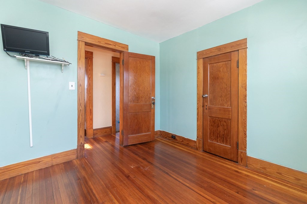 60 Roy Street Chicopee, MA 01013 - Photo 25 of 39 an empty room with wooden floor and windows