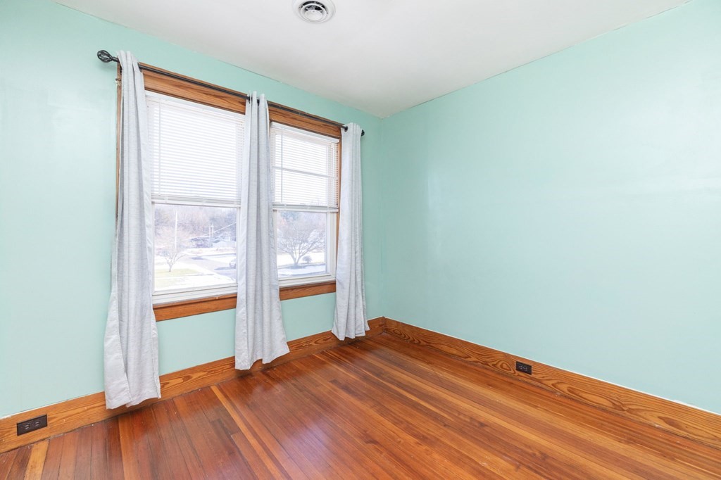 60 Roy Street Chicopee, MA 01013 - Photo 27 of 39 an empty room with wooden floor and windows