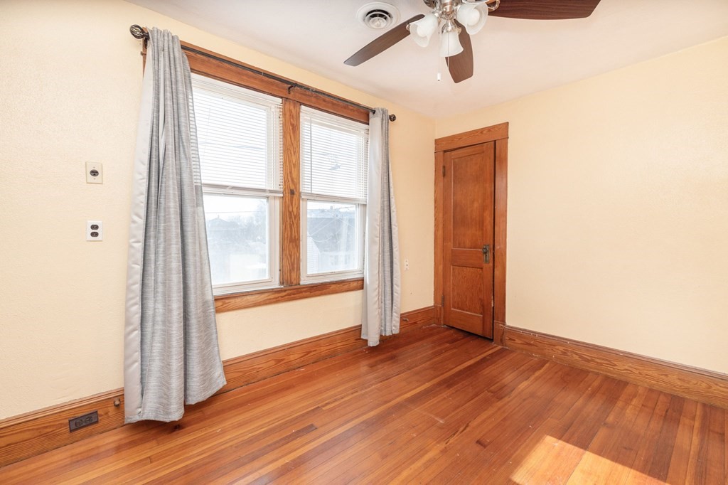 60 Roy Street Chicopee, MA 01013 - Photo 31 of 39 a view of an empty room with wooden floor and a window