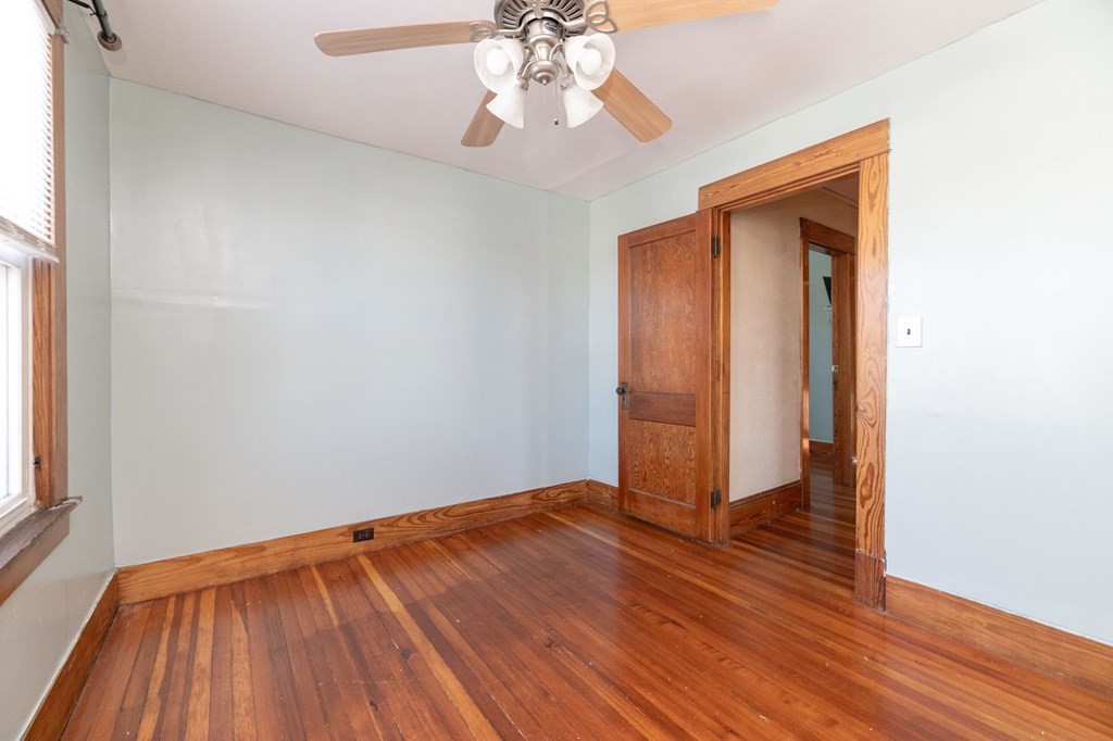 60 Roy Street Chicopee, MA 01013 - Photo 34 of 39 a view of an empty room with wooden floor and a window