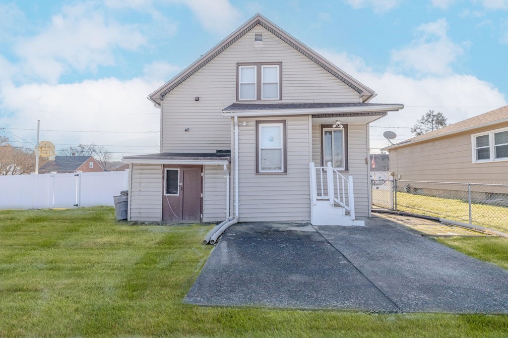 60 Roy Street Chicopee, MA 01013 - Photo 36 of 39 a front view of a house with a yard and garage