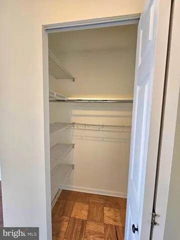 a view of walk in closet with an empty space