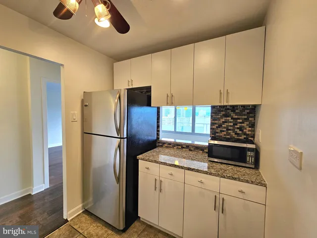 a kitchen with appliances a refrigerator and a stove