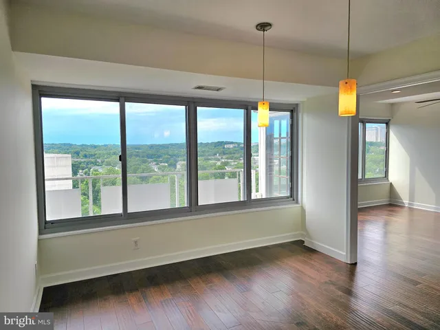 a view of a room with wooden floor and windows