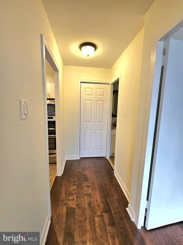 a view of a hallway with wooden floor and glass door