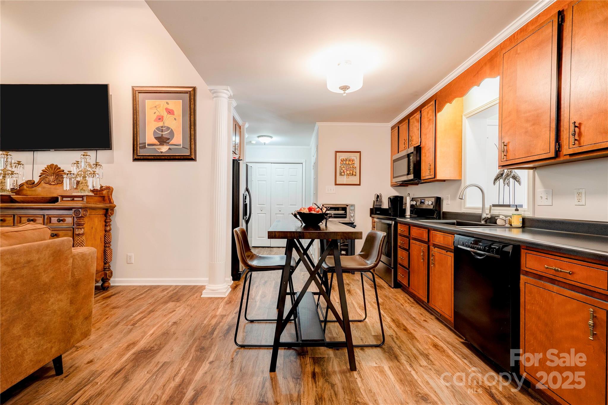 411 El Bethel Road Kings Mountain, NC 28086 - Photo 14 of 42 a kitchen with stainless steel appliances wooden floor dining table and chairs