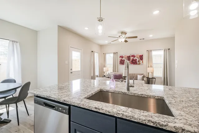 a kitchen with granite countertop a sink and a window