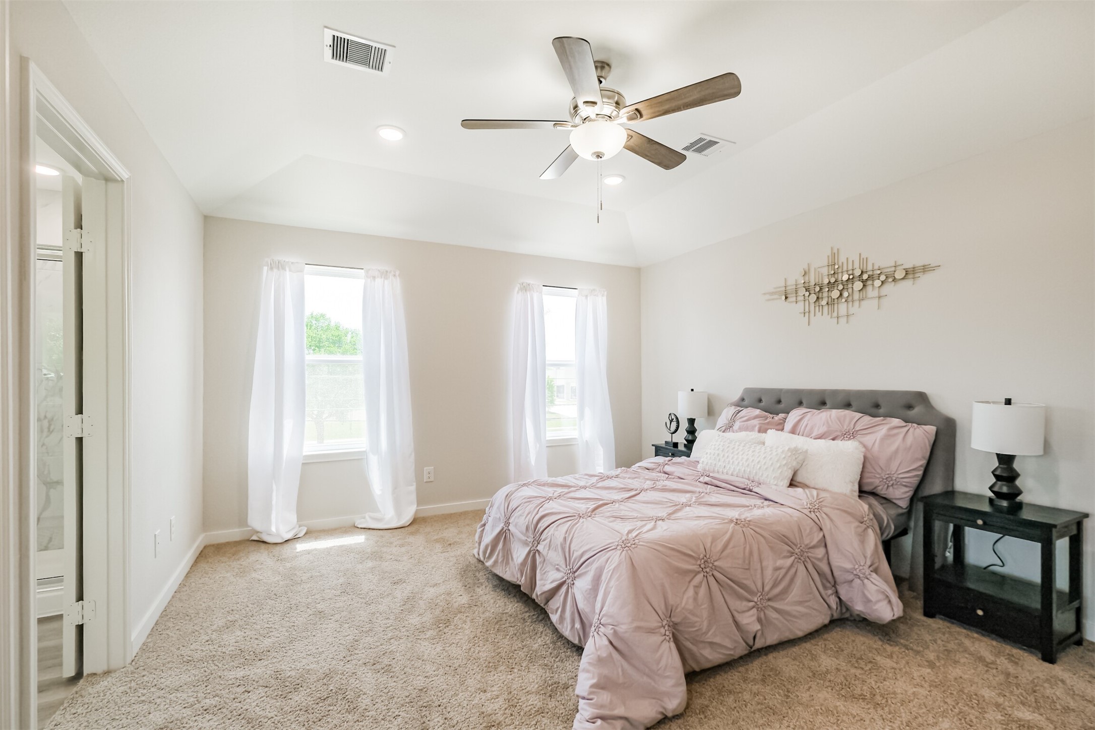 703 Majestic Eagle Court Houston, TX 77090 - Photo 22 of 40 a bedroom with a large bed and a chandelier