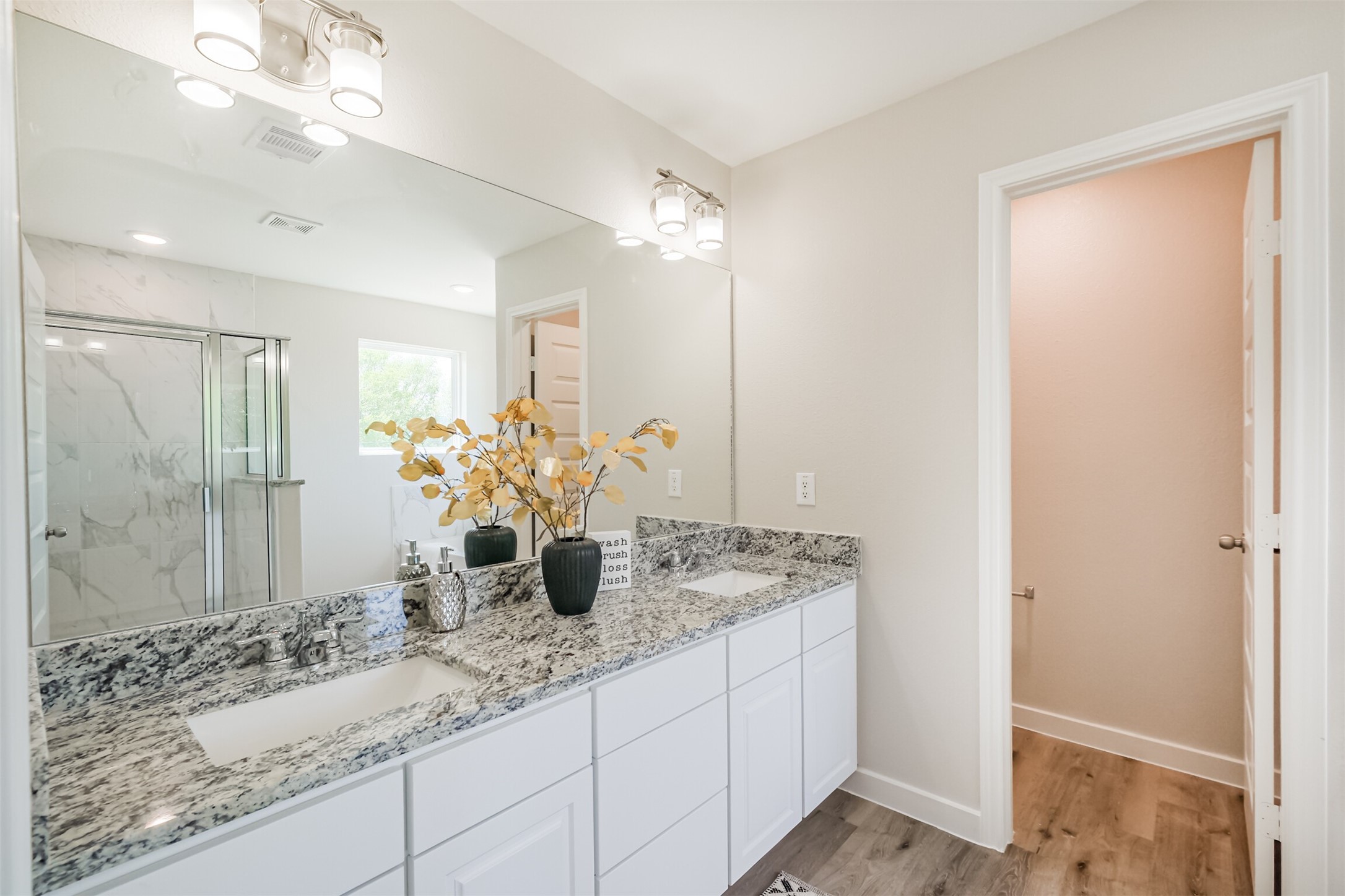 703 Majestic Eagle Court Houston, TX 77090 - Photo 25 of 40 a bathroom with a granite countertop sink and a mirror