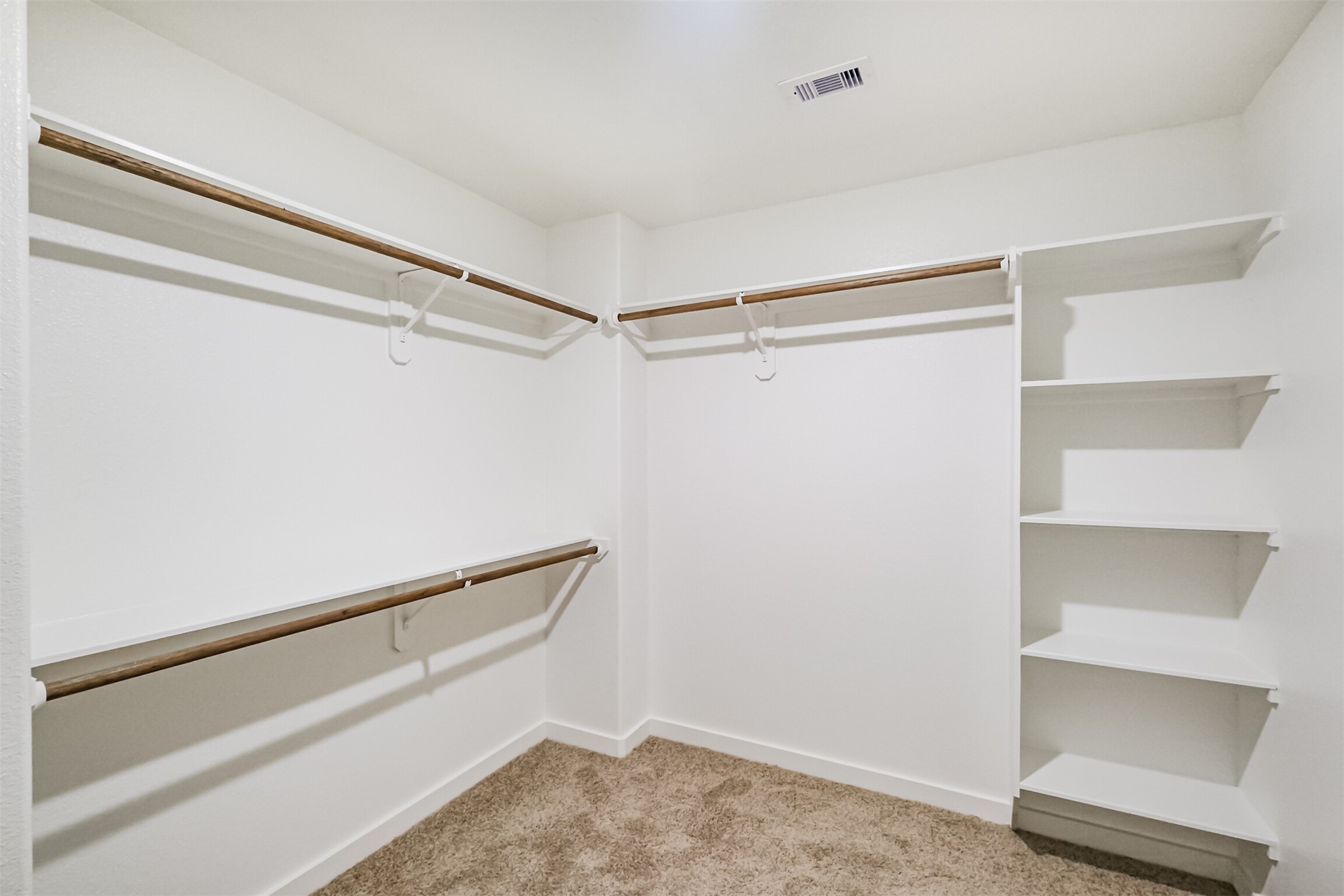 703 Majestic Eagle Court Houston, TX 77090 - Photo 27 of 40 a view of an empty walk in closet