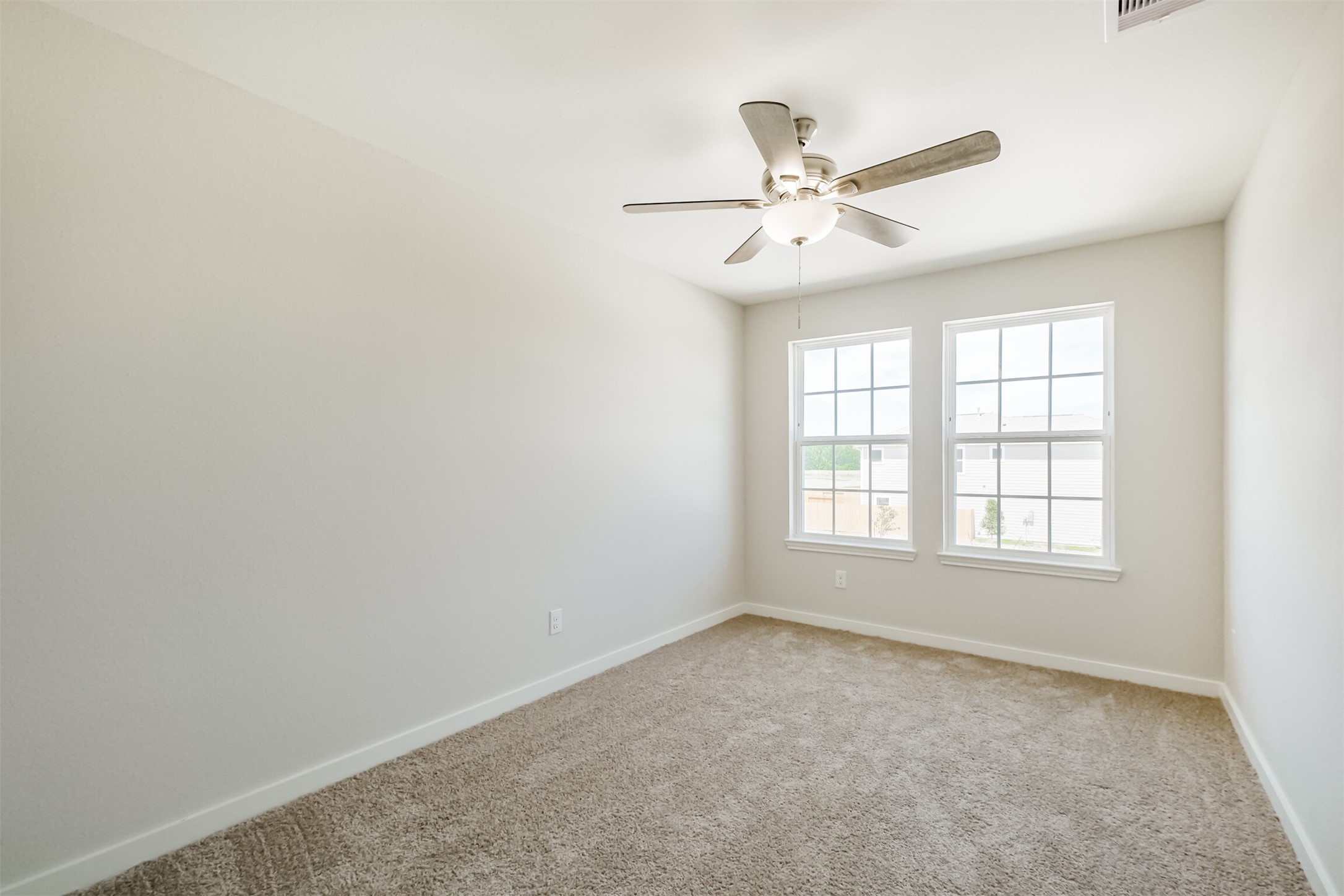 703 Majestic Eagle Court Houston, TX 77090 - Photo 28 of 40 an empty room with a window and a fan