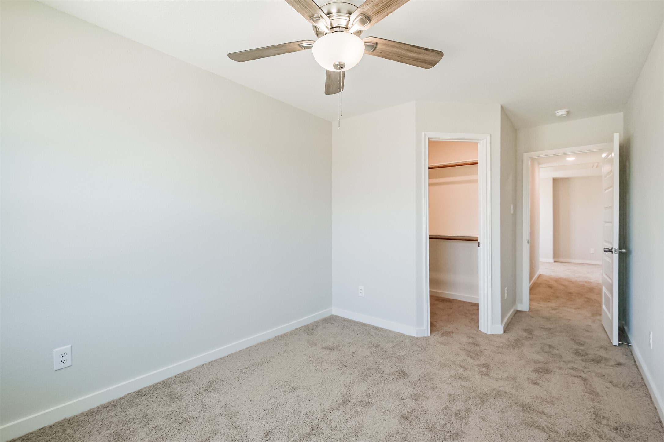 703 Majestic Eagle Court Houston, TX 77090 - Photo 32 of 40 an empty room with closet and a chandelier fan