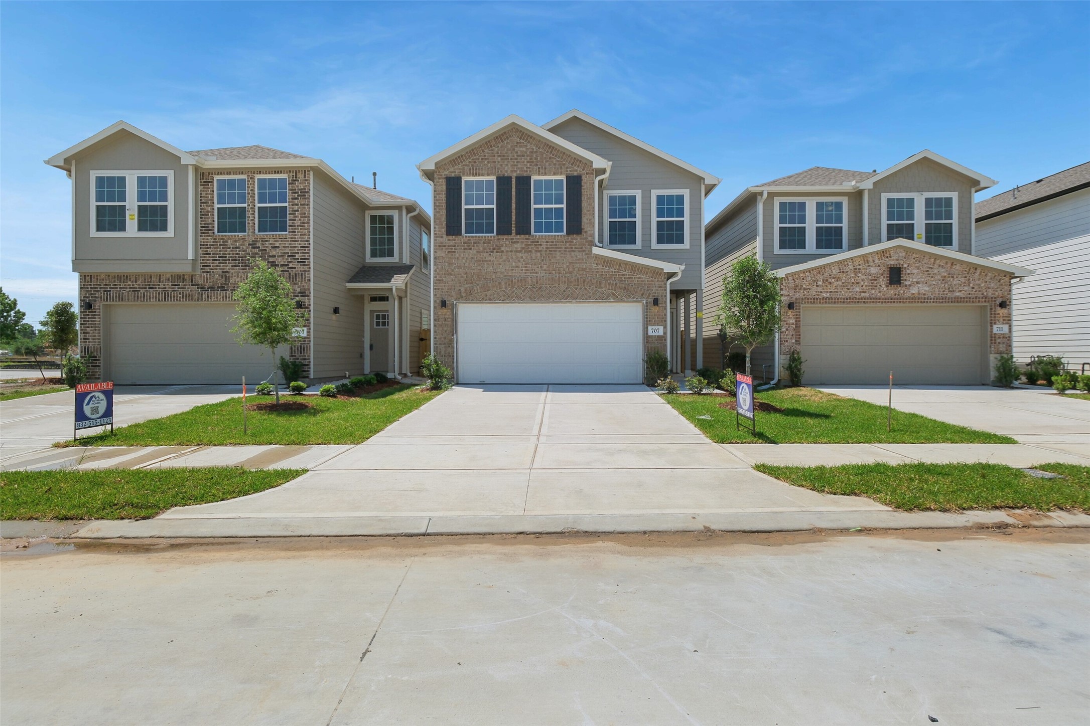 703 Majestic Eagle Court Houston, TX 77090 - Photo 39 of 40 a front view of a house with a yard and garage