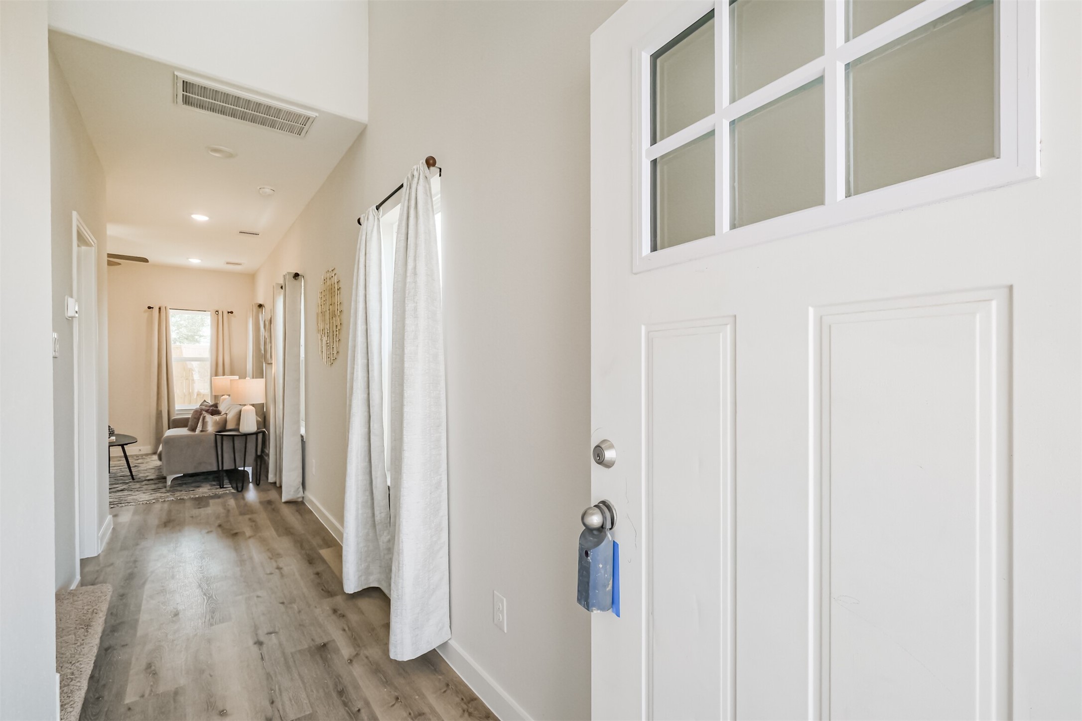 703 Majestic Eagle Court Houston, TX 77090 - Photo 5 of 40 a view of a hallway with bathroom and wooden floor