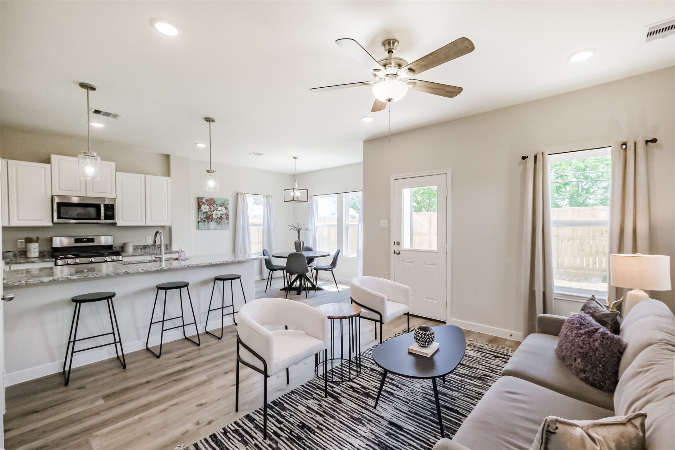 703 Majestic Eagle Court Houston, TX 77090 - Photo 6 of 40 a living room with furniture kitchen view and a window