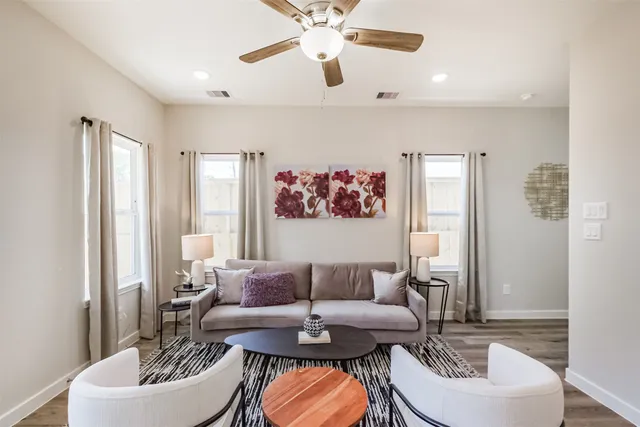 a living room with furniture and a potted plant