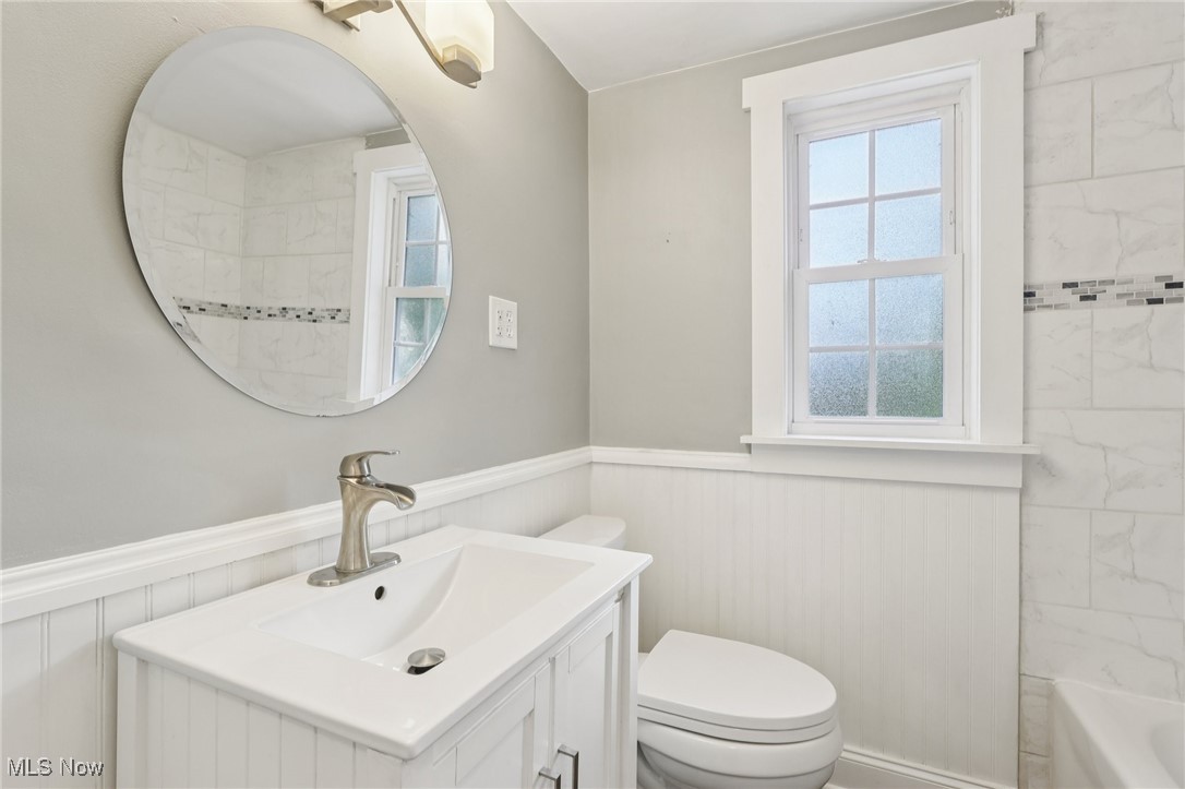 1151 Croyden Road Lyndhurst, OH 44124 - Photo 24 of 37 Full bathroom featuring wainscoting, vanity, and shower / washtub combination