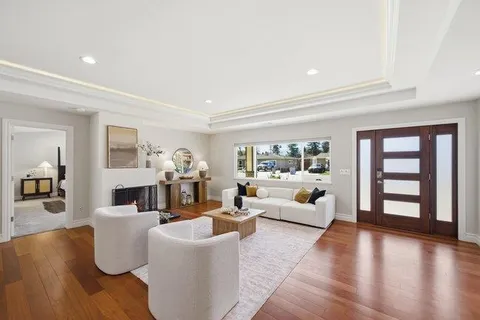 a kitchen with granite countertop a stove a oven a dining table and chairs with wooden floor
